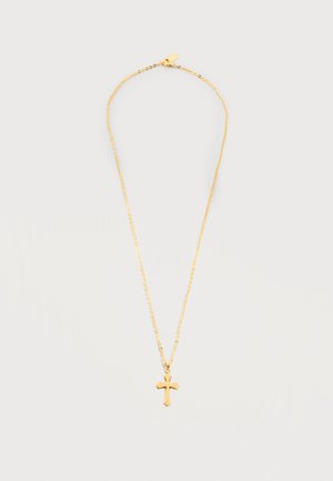 Gouden ketting met een kleine gepolijste kruisvormige hanger op een eenvoudige lichte achtergrond.