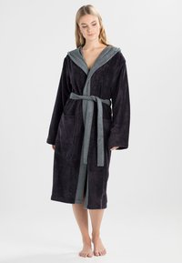Purple terry cloth bathrobe with a gray hood, belt, and pockets; features long sleeves and a soft, textured fabric.