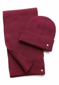 Burgundy knitted hat and scarf set. Scarf has a ribbed texture; hat features a cuff. Small logo detail on the hat's side.
