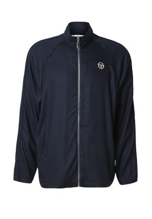 Veste légère bleu marine avec fermeture éclair complète à l'avant, col montant, manches longues, poches latérales et petit logo blanc sur la poitrine.