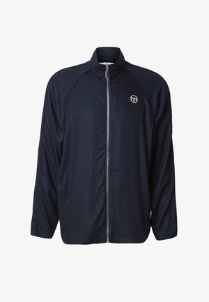 Veste légère bleu marine avec fermeture éclair complète à l'avant, col montant, manches longues, poches latérales et petit logo blanc sur la poitrine.