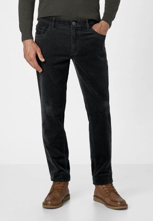 Black corduroy jeans with a straight-leg fit, featuring front pockets and a soft texture, paired with brown lace-up boots.