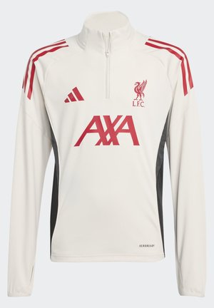 Haut d'entraînement blanc à manches longues de Liverpool FC avec des logos rouges, col à demi-zippé, bandes rouges aux épaules et panneaux latéraux noirs.