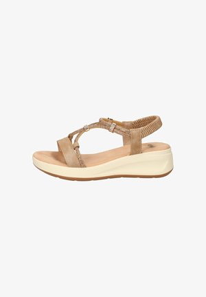 Sandalo con zeppa beige con cinturino elastico sul retro, cinturini laterali decorativi, soletta imbottita e suola bianca per uso quotidiano.