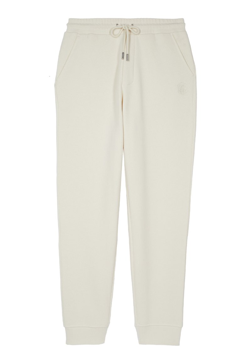 Pantalones deportivos color crema con puños elásticos, cintura ajustable con cordón, bolsillos laterales y un sutil logotipo en relieve en el muslo derecho.