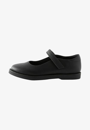 Black leather Mary Jane shoe with a rounded toe, flat sole, and a single strap across the instep. Smooth texture and minimalistic design.