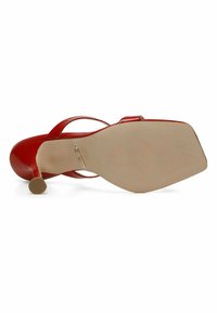 Red patent leather high-heeled sandal with a pointed toe and a tapered heel. Smooth texture and minimalist design with a nude sole.