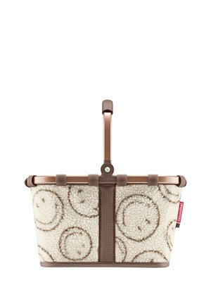 Foldable shopping basket with a beige soft fabric decorated with brown smiley faces and a brown handle on a white background.