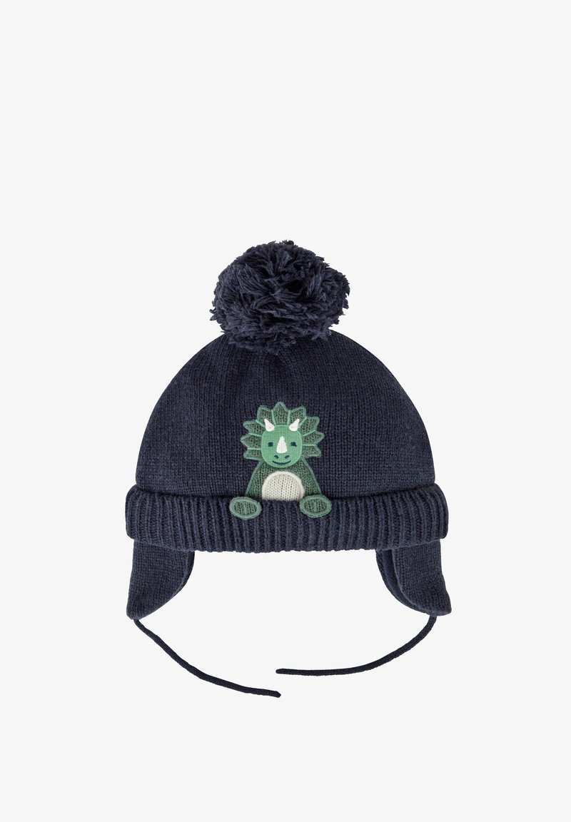 Zilā adīta cepure ar pūkainu pom-pom, ar zaļa dinozaura aplikāciju priekšpusē un ausu atlociem ar auklām siltumam.