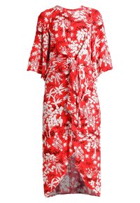 Robe fleurie rouge avec un détail noué à la taille, des manches courtes et une fente sur le devant. Le tissu a une texture lisse et légère.