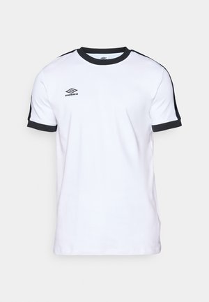 Bela kratka majica s kratkimi rokavi z enim črnim ovratnikom in stranskimi ploščami. Ima logo "Umbro" na prsih. Narejena je iz gladkega, zračnega materiala.