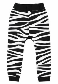 Schwarz-weiße, zebra gestreifte Jogginghose mit elastischem Bund und gerippten Knöcheln. Hergestellt aus einem weichen, bequemen Stoff.