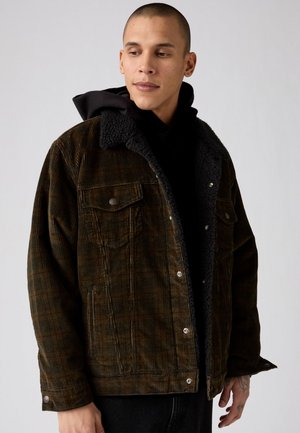 Brown corduroy jacket with a black fleece collar, featuring two front pockets, snap buttons, and a relaxed fit. Textured fabric with a check pattern.