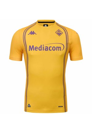 Maglia da calcio gialla a maniche corte con sponsor viola "Mediacom", loghi Kappa e stemma del club Fiorentina, con strisce viola lungo i lati.
