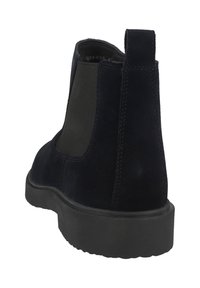 Botas Chelsea de ante negro con paneles laterales elásticos, una lengüeta y una suela de goma duradera para mayor tracción.