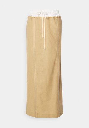 Pikk beež lina seelik, millel on elastne valge vöökoht, joonistuspaelaga sulgemine ja kontrastne õmblus külgedel.