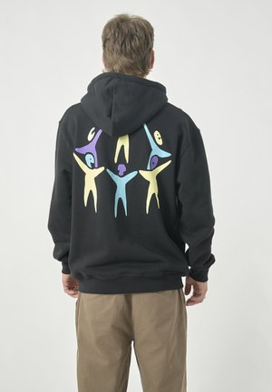 Black hoodie featuring a colorful abstract design of figures on the back, with shades of blue, yellow, and purple. Soft fabric, relaxed fit.