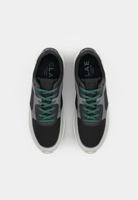 Black and gray athletic sneakers with mesh and synthetic upper, teal laces, and a white sole. Flat lace design and padded collar.