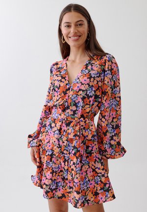 Floral wrap dress with long sleeves, featuring colorful orange, pink, and purple flowers on a black background; ruffled hem and tie waist.