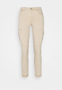 Beige cargo-housut, jotka on valmistettu puuvillasta, kapea malli, sivutaskut, polvitäplät ja risat helmat alaosassa.