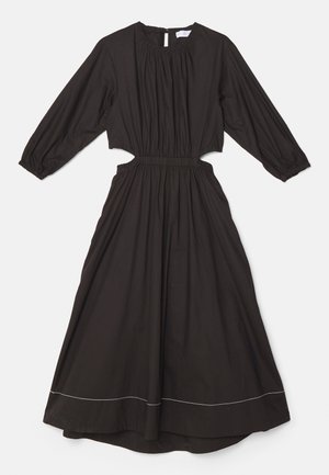 Vestido de algodón negro con mangas largas, escote fruncido y cintura elástica. Presenta cortes laterales y costuras blancas en el dobladillo.