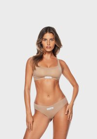 Ensemble de soutien-gorge et bikini beige en tissu lisse, avec une étiquette logo au centre. Design simple et finition sans couture.