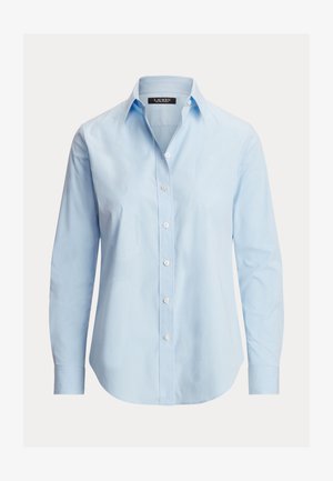 Vaaleansininen puuvillainen nappipaita, jossa on kaulus, pitkät hihat ja kaartuva helma. Paidassa on valkoiset napit ja hienovaraiset tekstuurikuviot.