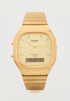 Arany tónusú Casio kvarc óra négyzet alakú számlappal, sárga számlappal, analóg mutatókkal, digitális kijelzővel és fém szemcsés szíjjal. Vízálló.