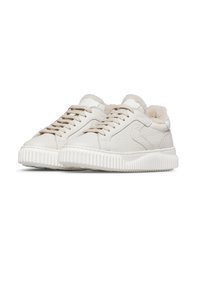 Pair of cream-colored low-top sneakers with textured leather, lace-up front, thick ridged soles, and plush fur lining visible at the collar.