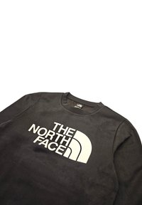 Sudadera negra hecha de una mezcla de algodón y poliéster, que presenta un gran logo blanco "THE NORTH FACE" con un diseño en arco. Cuello redondo clásico.