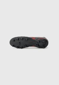 Black and red soccer cleat with a textured upper, featuring a curved shape, prominent studs on the outsole, and a mesh design for breathability.