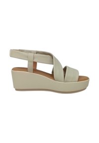 Sandali con zeppa beige con tomaia in pelle liscia e design delle cinghie a incrocio. Presentano una soletta imbottita e suola in gomma.