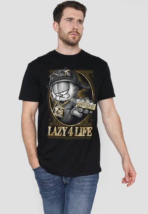 Black cotton t-shirt featuring a cartoon-style graphic of a character wearing a cap, with gold accents and the text "LAZY 4 LIFE."