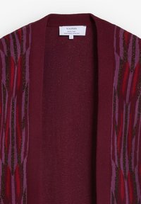Burgundy cardigan with a textured weave and vertical striped pattern in shades of red and purple, featuring metallic thread accents.