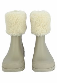 Beige waterdichte laarzen met donzige roomkleurige bontboorden. Glad exterieur met een getextureerde zool en een ronde bovenkant, ontworpen voor warmte en comfort.