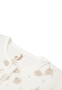 Bodysuit en coton crème avec imprimé floral beige. Doté d'un col rond et d'une fermeture à pressions, étiqueté pour une taille de 60 cm. Texture douce.