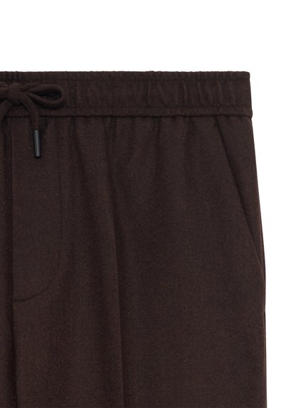 Bruine sweatpants in een zachte, gemêleerde stof met een elastische tailleband, trekkoord en zijzakken. Casual ontwerp met een losse pasvorm.