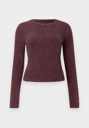 Dlhý rukáv, rebrovaný top v hlbokej burgundskej farbe. Má okrúhly výstrih a priliehavý strih. Vyrobené z mäkkej, textúrovanej látky.
