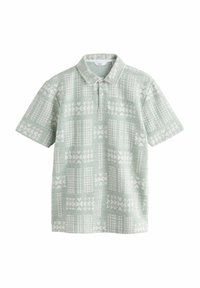 Korteærmet polo i lys grøn med et tekstureret stof, der har et hvidt geometrisk mønster og en klassisk krave.