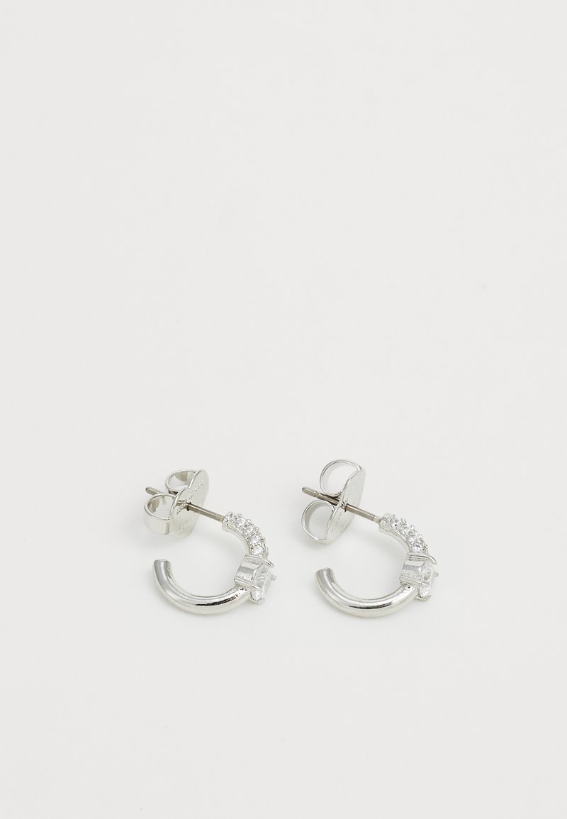 Silver hoop earrings with a curved design, featuring small clear crystals along one side and a post back for secure fastening.