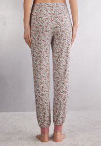 Floral pyjamabroek van lichtgewicht stof, met een pastelroze en groene bloemenprint, elastische enkels en een hoge tailleband.