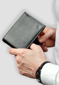 Black leather wallet with contrasting white stitching, textured surface, bi-fold design, and a subtle embossed logo on the front.