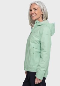 Hellmintgrüne wasserdichte Jacke mit Kapuze, Seitentaschen und Reißverschluss. Sie zeichnet sich durch eine glatte Textur und eine taillierte Passform aus.