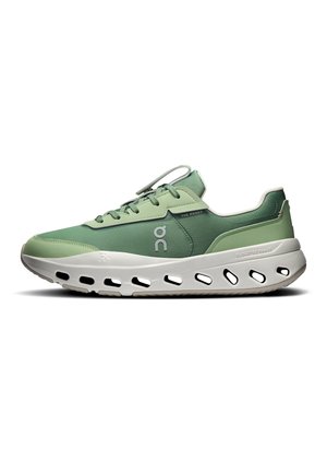 Green low-top running shoe with white sole featuring oval cutouts and branded side designs.