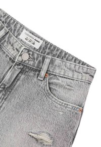 Jeans in denim grigio con aree strappate, design a cinque tasche, chiusura con bottone in metallo e etichetta che indica la taglia e il marchio.