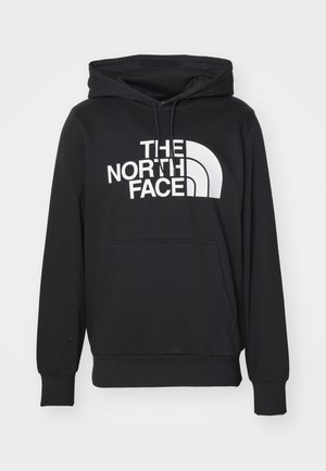 Black hoodie made of cotton blend, featuring a front kangaroo pocket, adjustable drawstring hood, and large white logo on the chest.