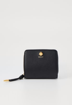 Black leather wallet with a textured finish, gold hardware logo, rounded edges, and a zip closure featuring a pull tab.