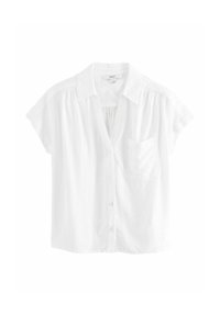 Camicia bianca a maniche corte con chiusura a bottoni, colletto e taschino sul petto; realizzata in tessuto leggero con una vestibilità leggermente ampia.