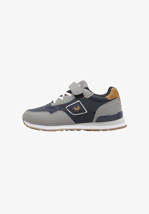 Zapatillas deportivas con una parte superior en azul marino y gris, materiales sintéticos, cordones blancos, correas de Velcro y acentos en contraste color marrón.