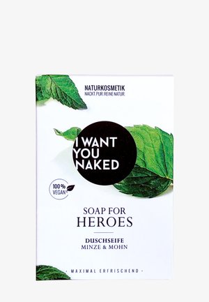 Emballage de savon avec des feuilles de menthe, étiqueté "Je te veux nu", 100 % végan, cosmétiques naturels, parfum menthe et graines de pavot, fraîcheur maximale.